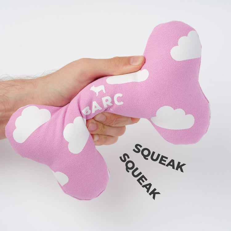 Pink Fabric Dog Bone Toy With Squeaky Function and White Cloud Design